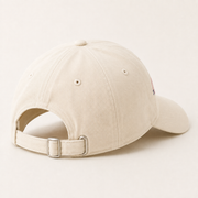 Representative rear three-quarter view of the Cream Pink Bow Mini Embroidery Dad Hat showing cotton twill and adjustable metal buckle